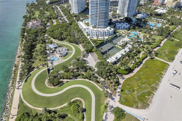 an aerial view of a house with outdoor space and swimming pool