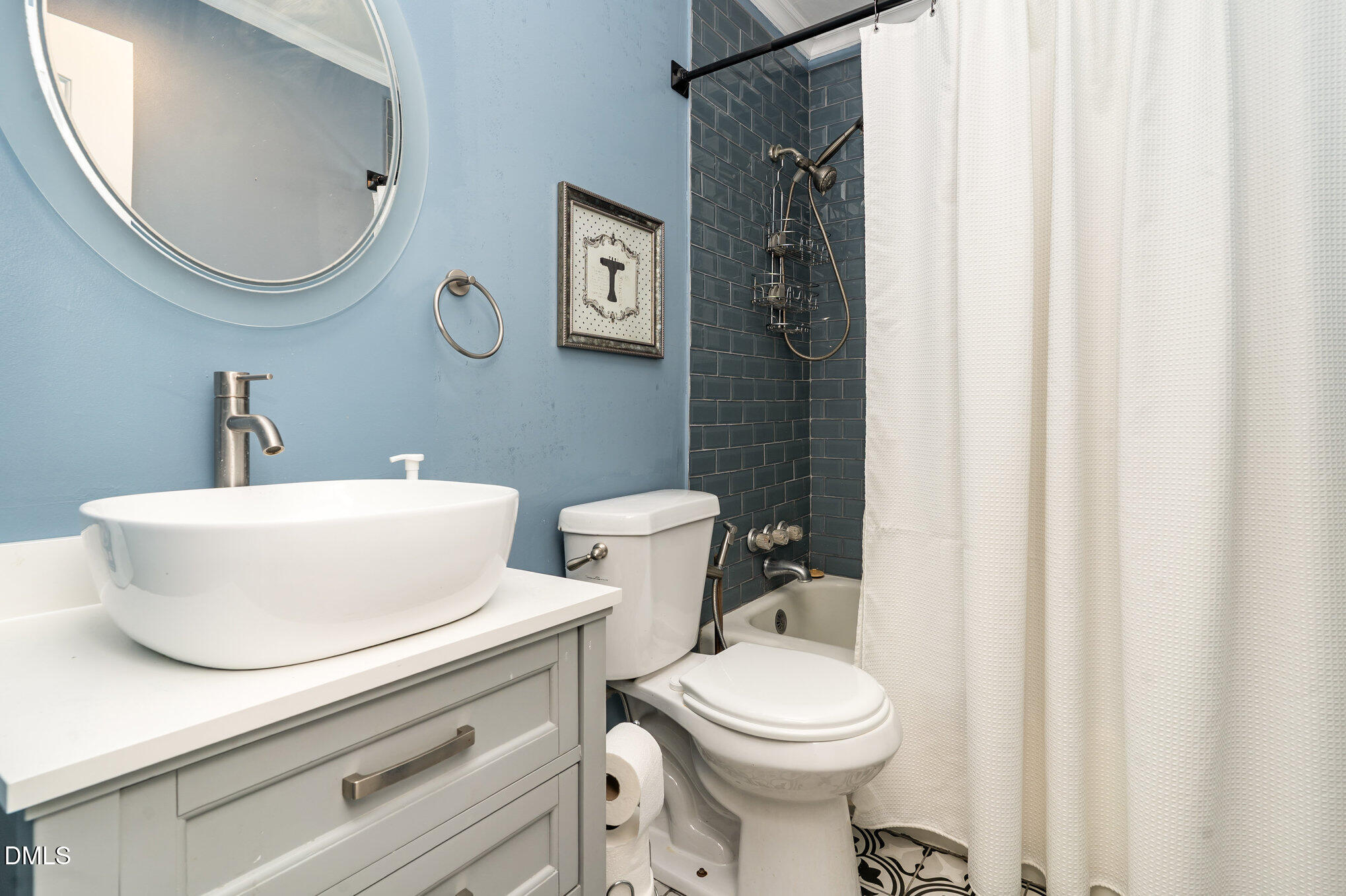 1002 Southerlund Road Garner, NC 27529 - Photo 9 of 12 a bathroom with a sink a mirror a toilet and a mirror