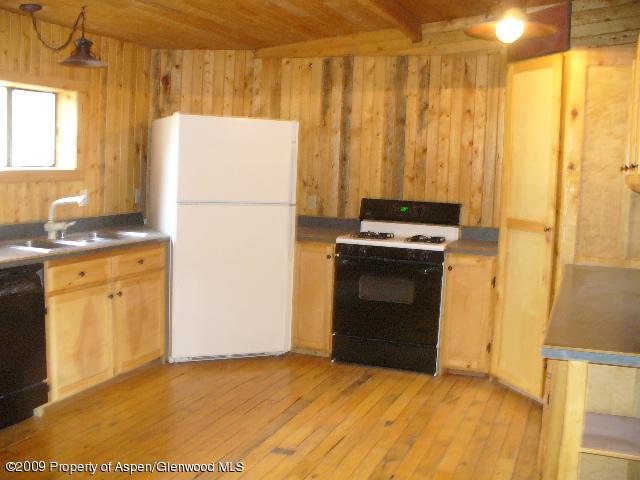 480 Jewell Lane, Unit C R 259 Rifle, CO 81650 - Photo 5 of 12 a kitchen with a stove a refrigerator and a sink