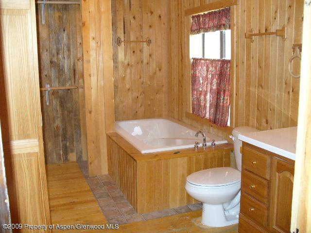 480 Jewell Lane, Unit C R 259 Rifle, CO 81650 - Photo 9 of 12 a bathroom with a sink a toilet and shower curtain