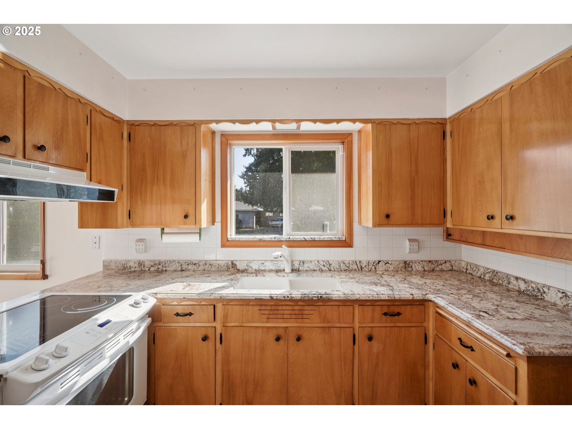 1727 Northeast 153rd Place Portland, OR 97230 - Photo 14 of 37 a kitchen with granite countertop a sink and a window