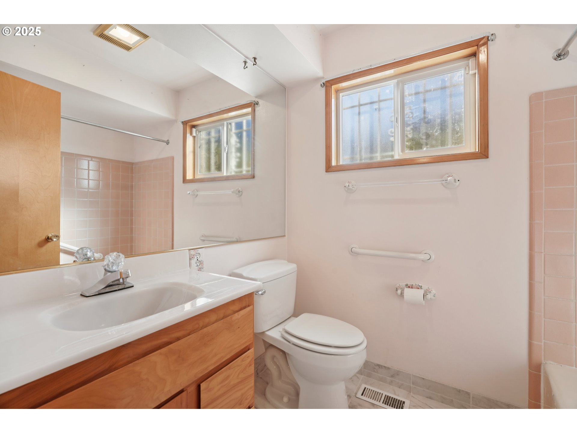 1727 Northeast 153rd Place Portland, OR 97230 - Photo 21 of 37 a bathroom with a toilet a sink a mirror and a window