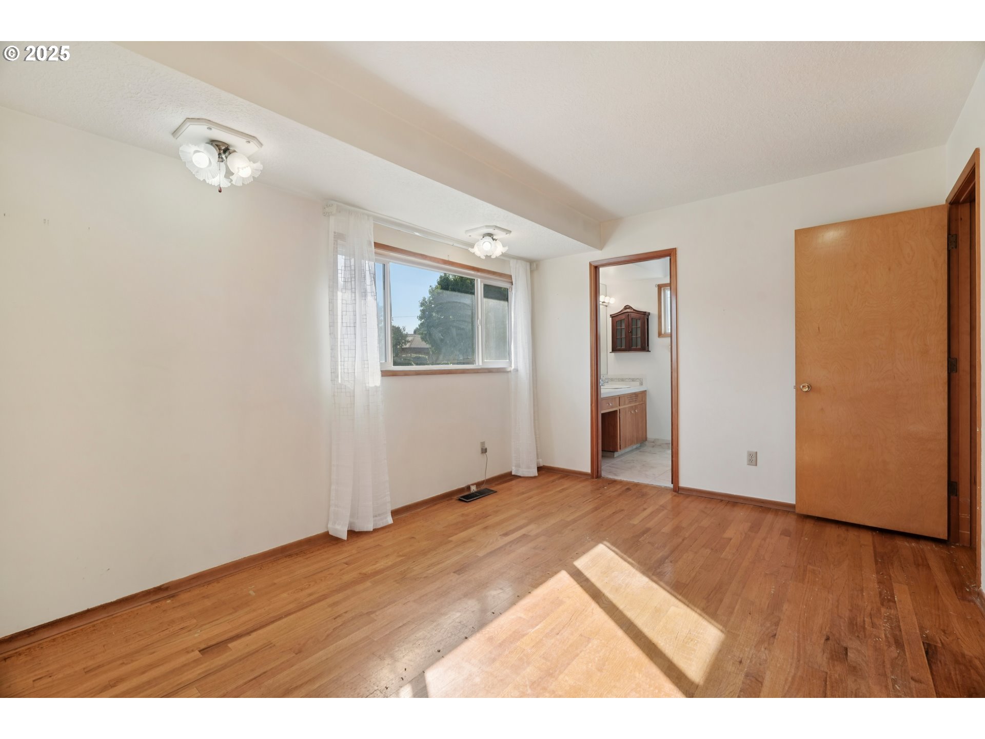 1727 Northeast 153rd Place Portland, OR 97230 - Photo 24 of 37 a view of an empty room with wooden floor and a window