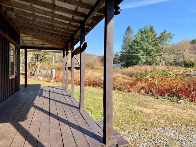 a view of a backyard with sitting area