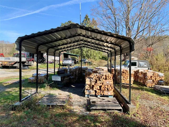 a view of river covered by trees and buildings