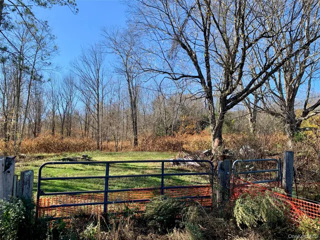 a view of a wooden deck with a yard