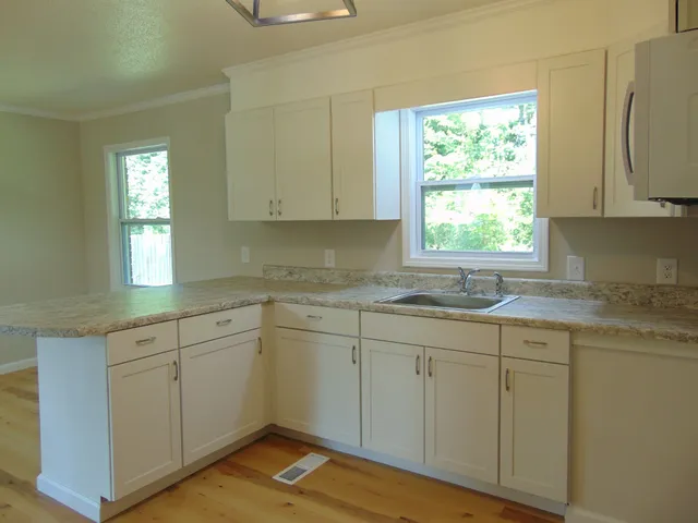 a kitchen with sink cabinets and window