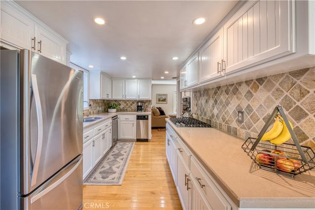 a kitchen with stainless steel appliances granite countertop a refrigerator sink and cabinets