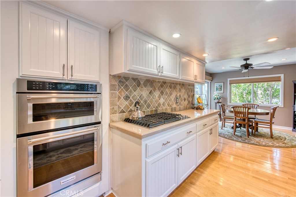 34052 Crystal Lantern Dana Point, CA 92629 - Photo 12 of 42 a kitchen with granite countertop a stove top oven and cabinets