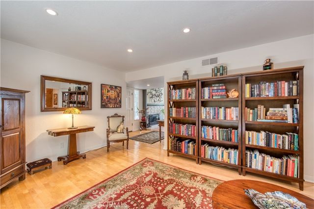 a living room with fireplace furniture and a book shelf