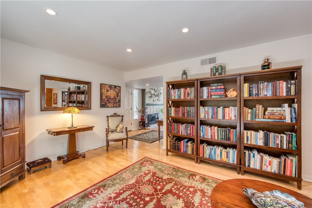 34052 Crystal Lantern Dana Point, CA 92629 - Photo 16 of 42 a living room with fireplace furniture and a book shelf