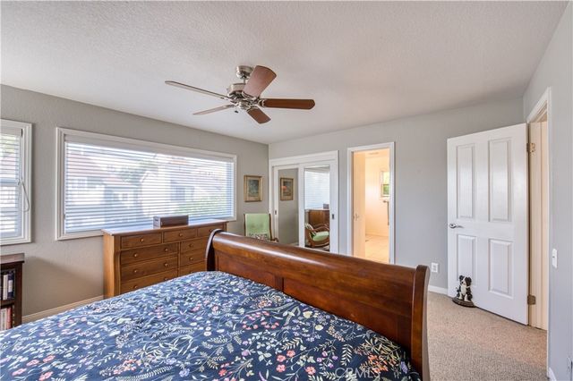 a bed room with a bed and a large window