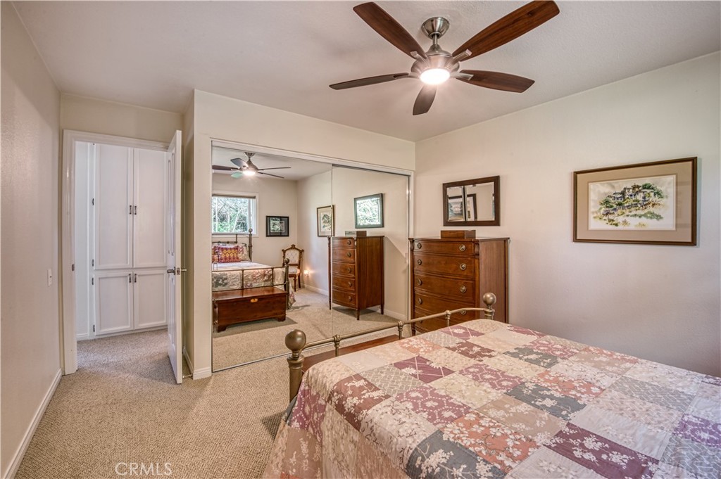 34052 Crystal Lantern Dana Point, CA 92629 - Photo 25 of 42 a bedroom with a large bed and a chandelier