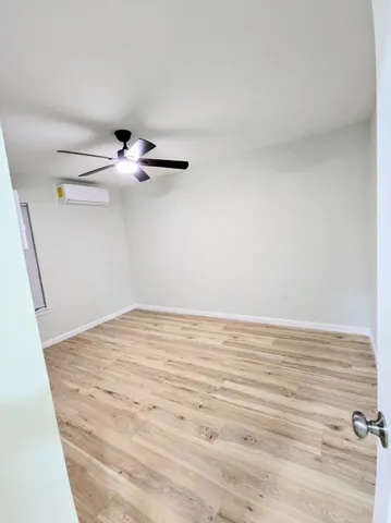 a view of a room with wooden floor