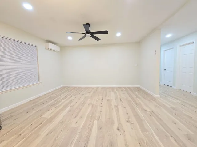 wooden floor in an empty room with a window