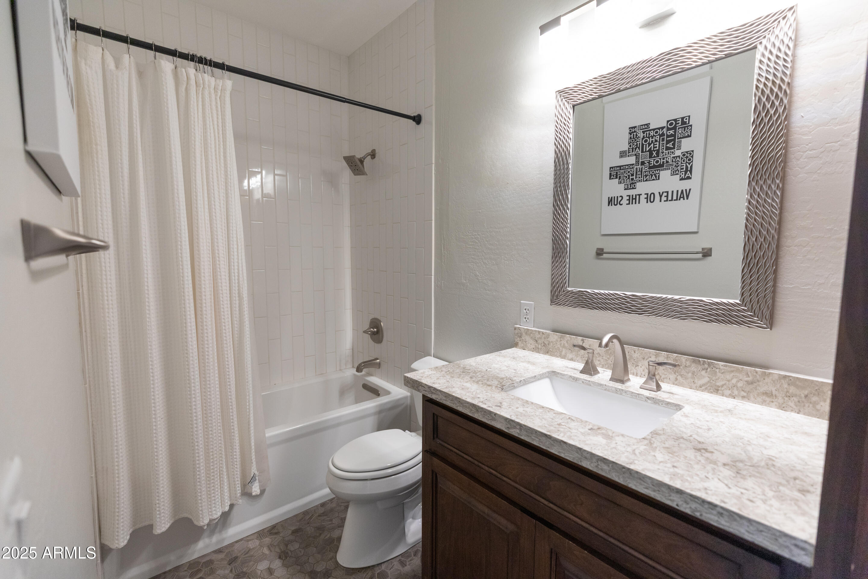 4759 South Granite Street Gilbert, AZ 85297 - Photo 15 of 29 a bathroom with a granite countertop sink a toilet and shower curtain