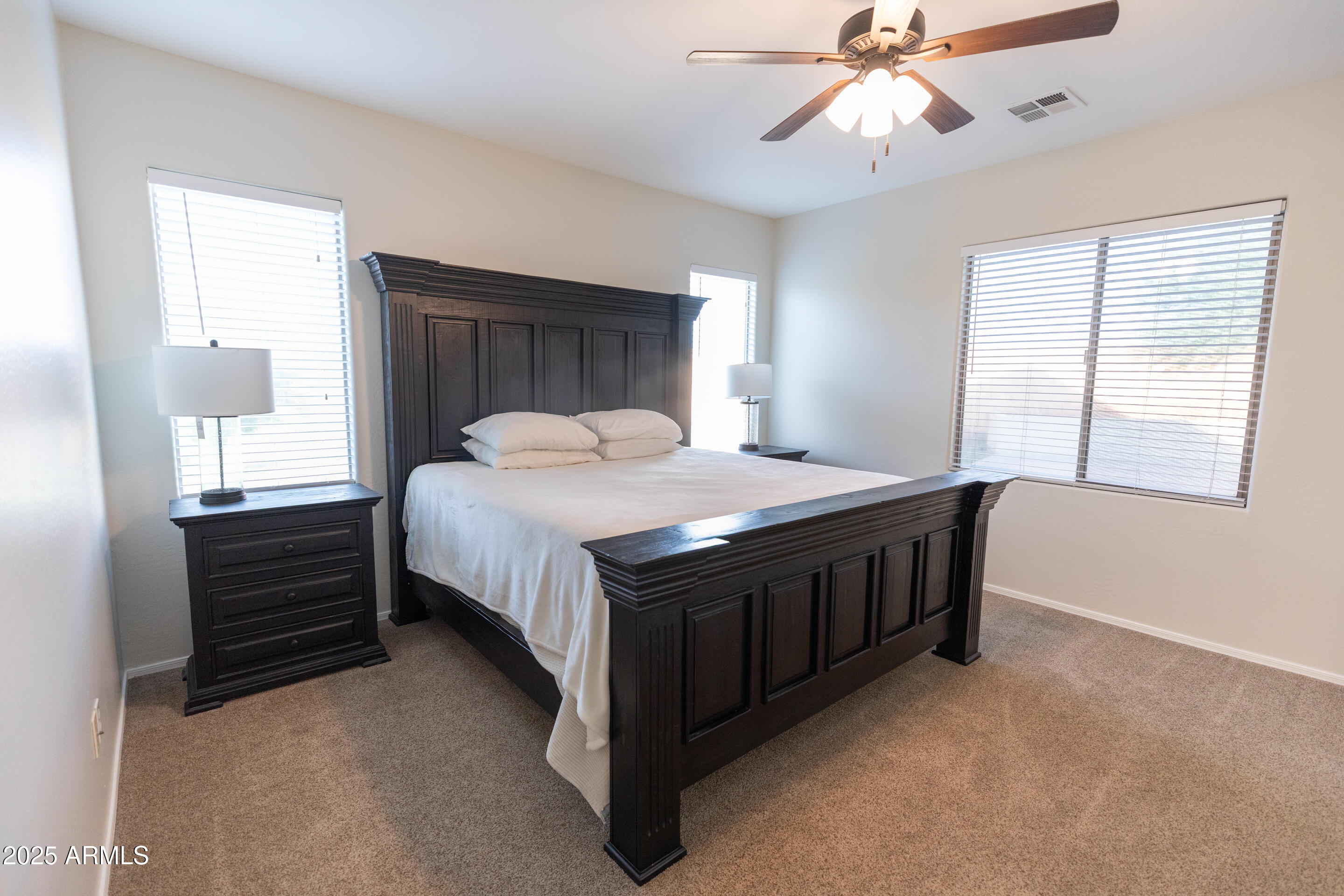 4759 South Granite Street Gilbert, AZ 85297 - Photo 16 of 29 a bed sitting in a bedroom next to a window