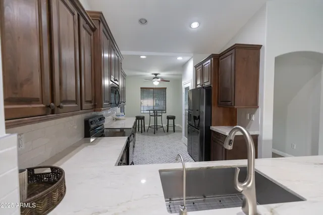 a kitchen with a table chairs sink and cabinets