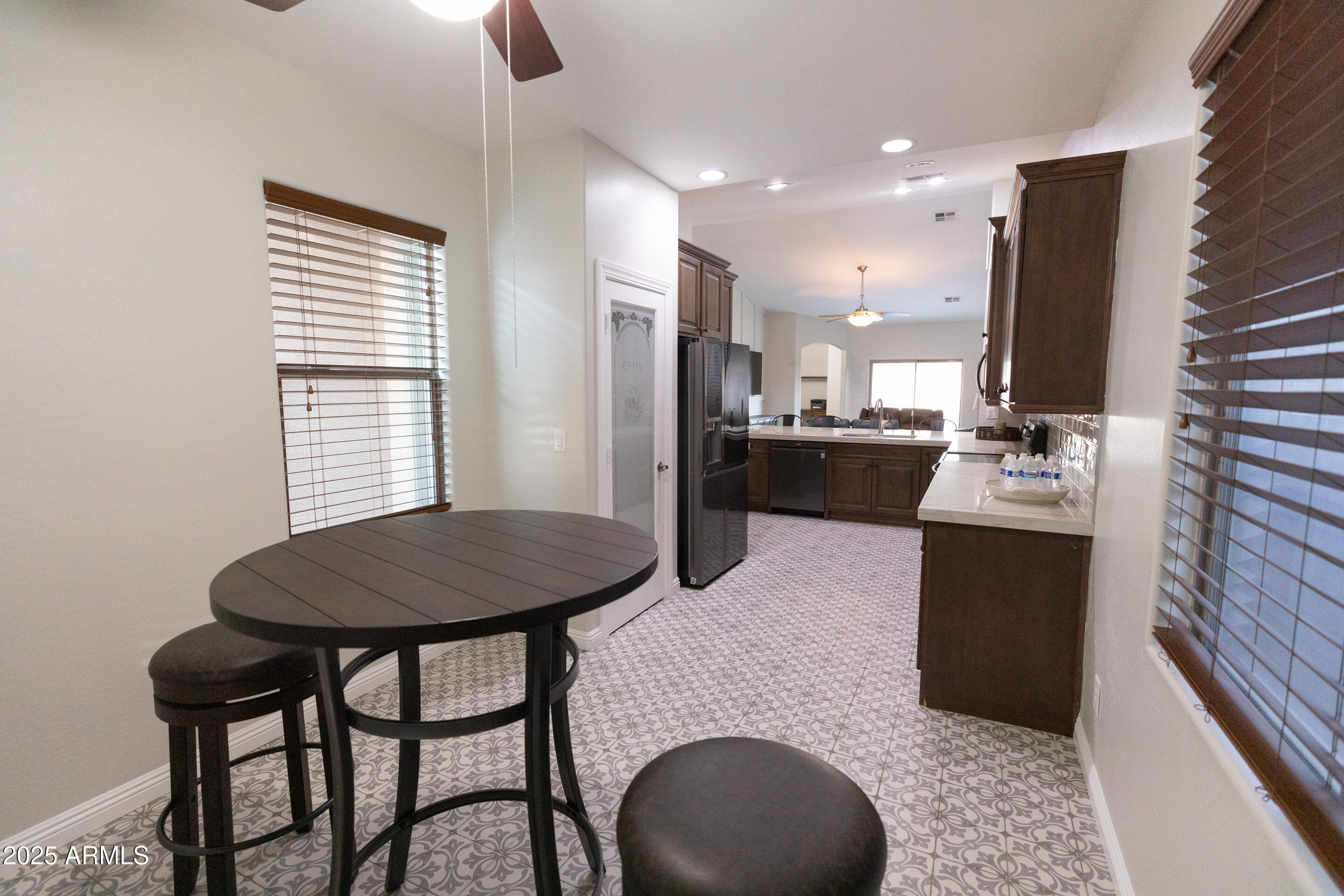 4759 South Granite Street Gilbert, AZ 85297 - Photo 7 of 29 a kitchen with a table chairs sink and cabinets