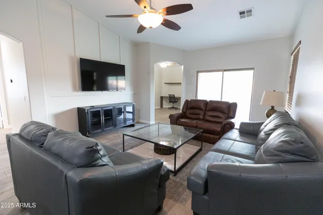 a living room with furniture and kitchen view