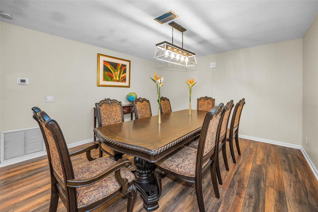11077 87th Avenue Seminole, FL 33772 - Photo 11 of 32 a view of a dining room with furniture and chandelier