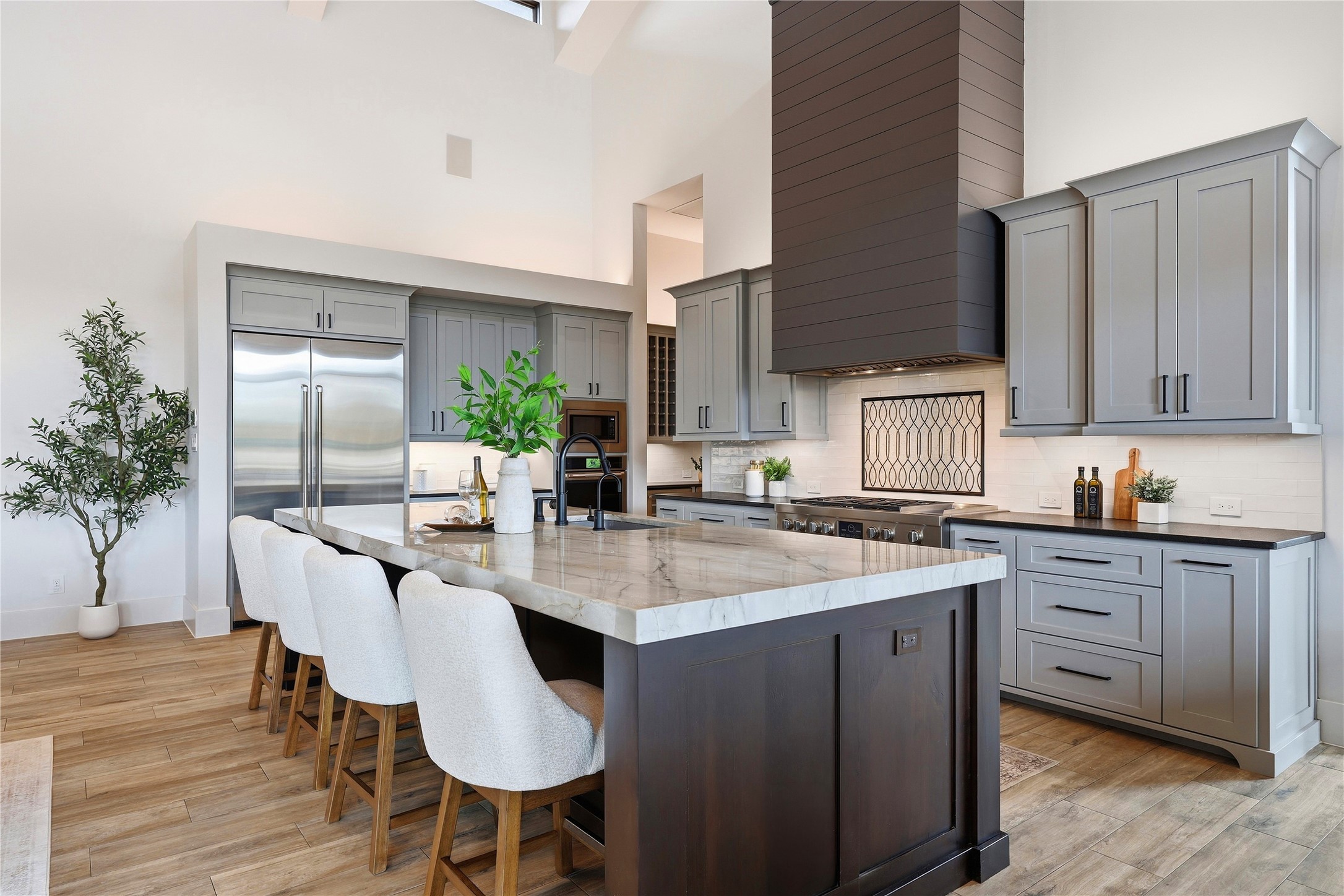 449 Ranch Falls Fair Oaks Ranch, TX 78015 - Photo 8 of 39 Soaring ceilings and a spacious central island anchor this beautifully appointed kitchen space.