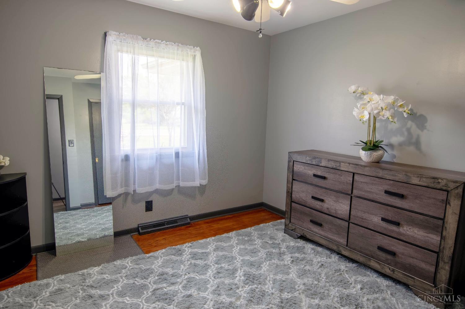 3781 Eaton Road Hamilton, OH 45013 - Photo 10 of 33 Bedroom 1 with featuring ceiling fan, hardwood floors, neutral paint, and energy efficient windows.