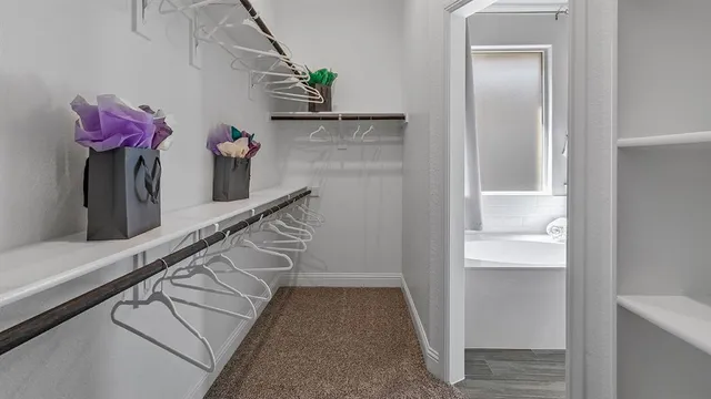 a spacious bathroom with a sink and a mirror