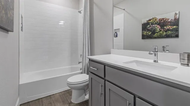 a living room with furniture a flat screen tv and a window