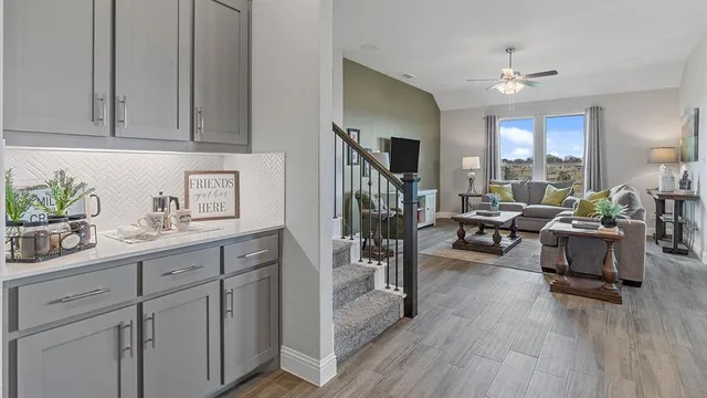 a kitchen with sink stove and wooden floor