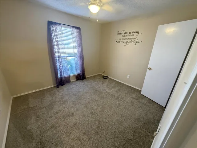 an empty room with windows and entrance