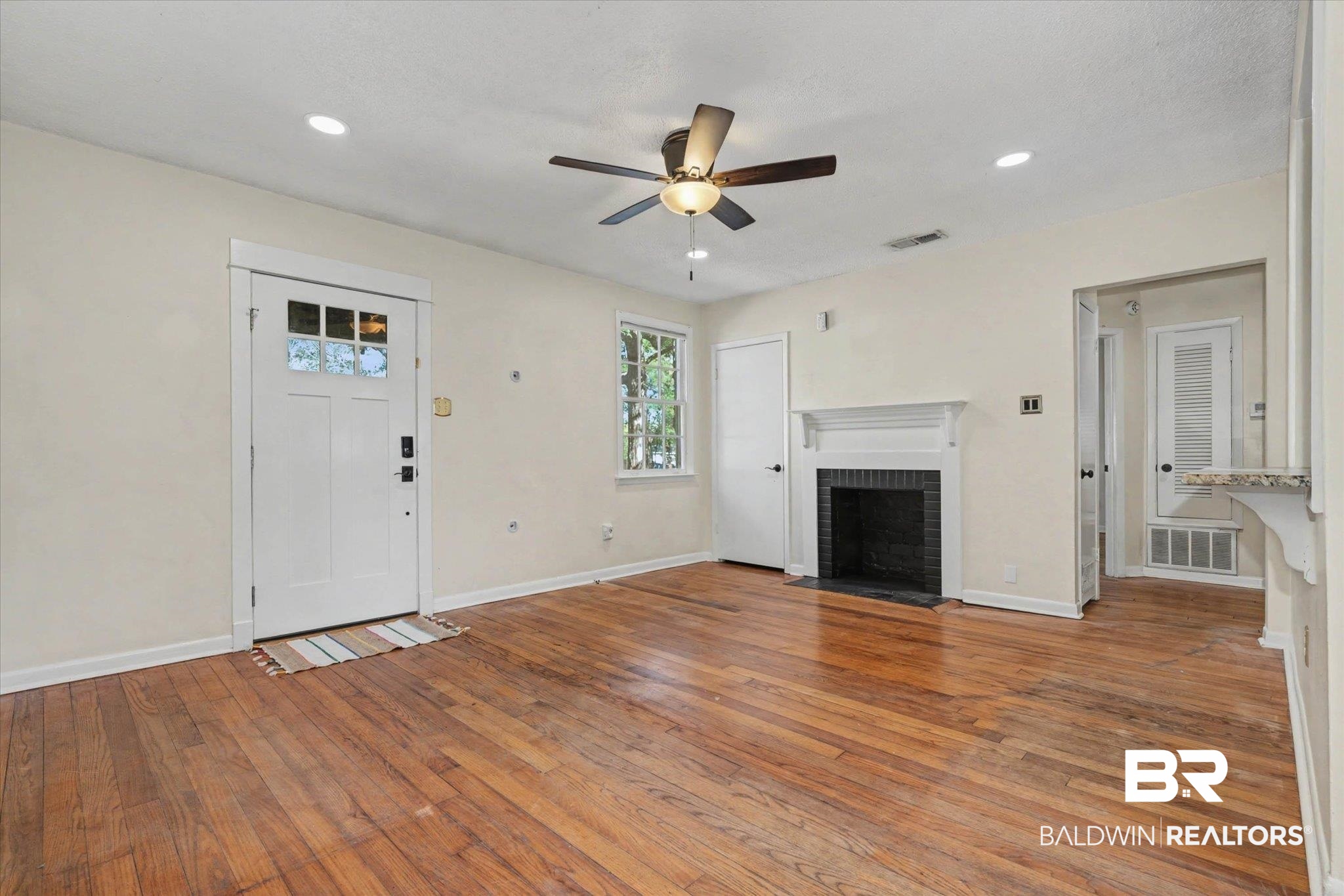 5117 Norton Lane Mobile, AL 36608 - Photo 8 of 35 Unfurnished living room featuring hardwood / wood-style floors, ceiling fan, a fireplace, and recessed lighting