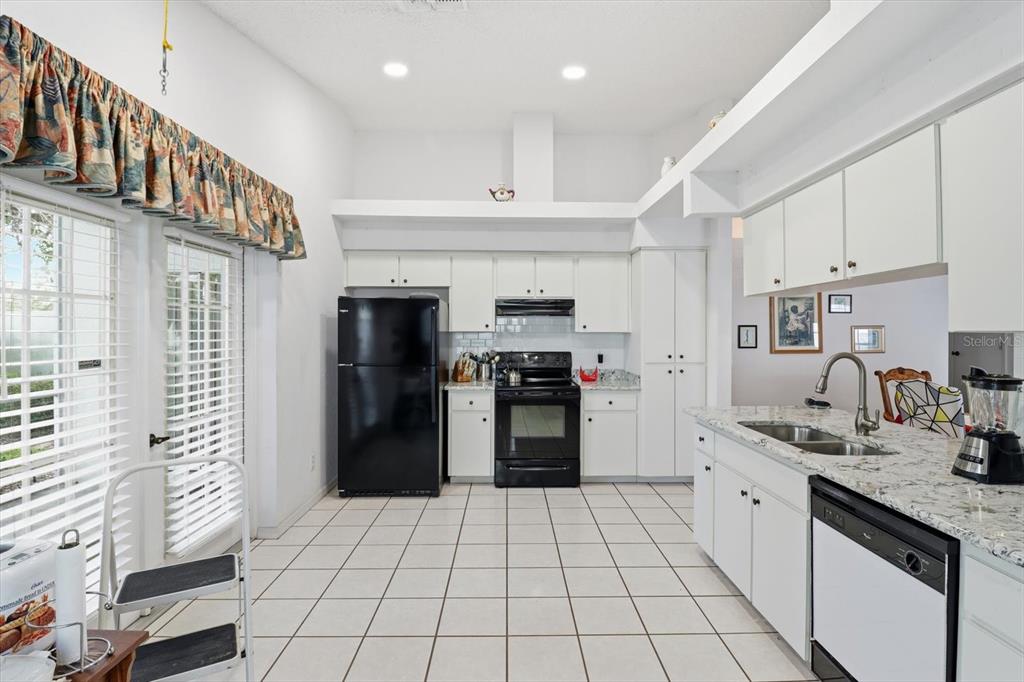 1046 Castille Drive Spring Hill, FL 34608 - Photo 16 of 44 a kitchen with stainless steel appliances granite countertop a refrigerator and a sink