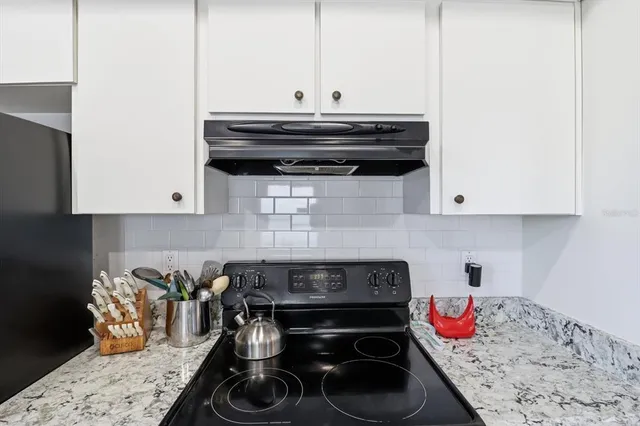 a bathroom with a granite countertop tub sink and mirror