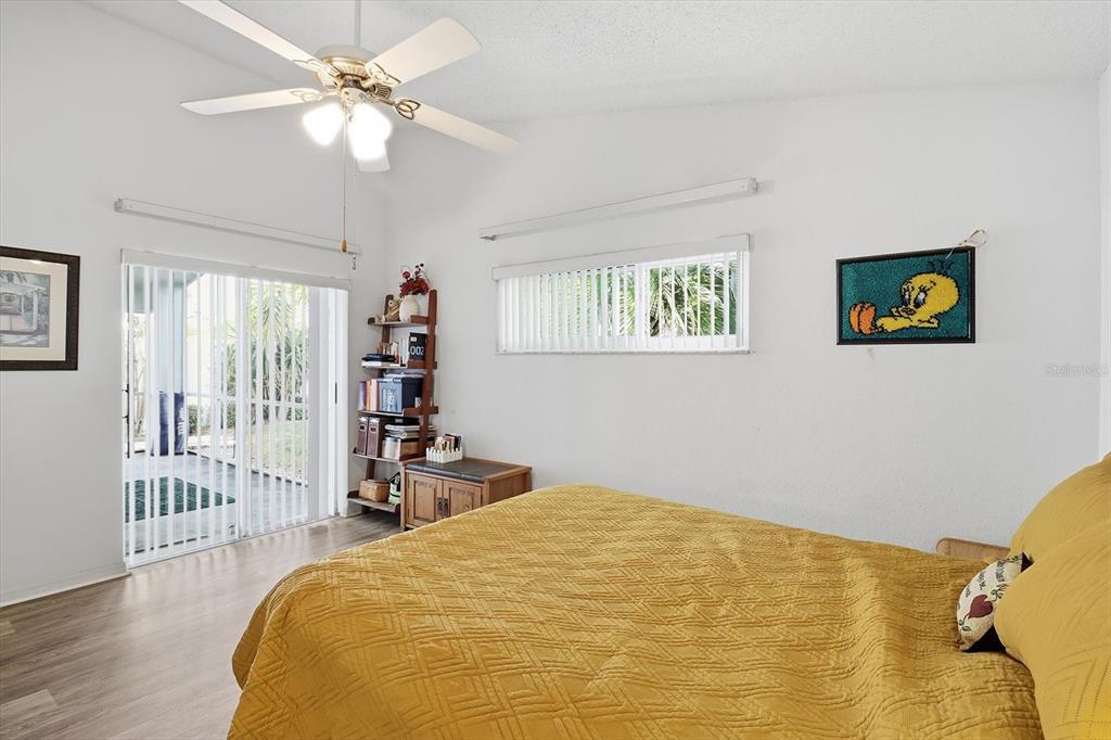 1046 Castille Drive Spring Hill, FL 34608 - Photo 21 of 44 a bedroom with a bed and a chandelier