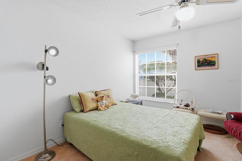 1046 Castille Drive Spring Hill, FL 34608 - Photo 25 of 44 a bedroom with a bed and window