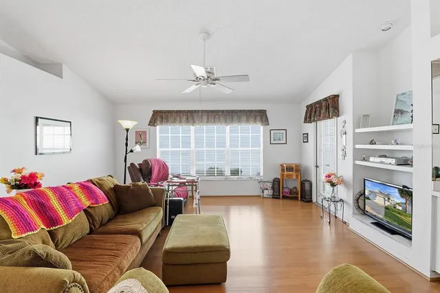 a living room with furniture and flowers