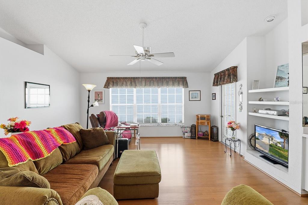 1046 Castille Drive Spring Hill, FL 34608 - Photo 9 of 44 a living room with furniture and a fireplace