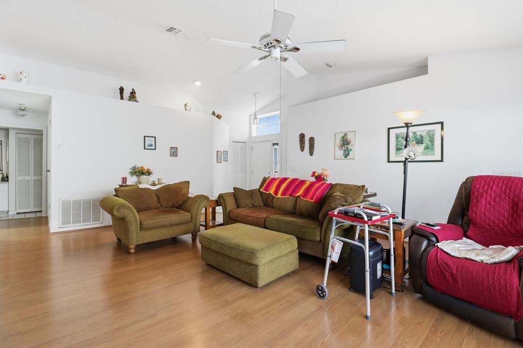 1046 Castille Drive Spring Hill, FL 34608 - Photo 10 of 44 a living room with furniture and wooden floor