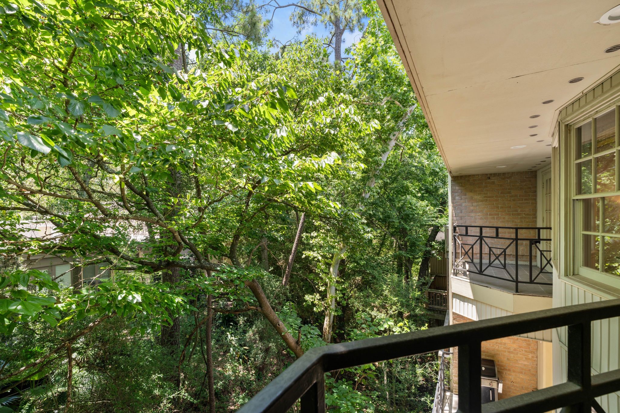 201 Vanderpool Lane, Unit 137 Houston, TX 77024 - Photo 21 of 42 Step out onto the private balcony directly from the primary suite or across the way from the primary bathroom for your morning cup of coffee or evening glass of wine, surrounded by peaceful views of the trees. It’s the kind of quiet retreat that makes this space feel truly special.