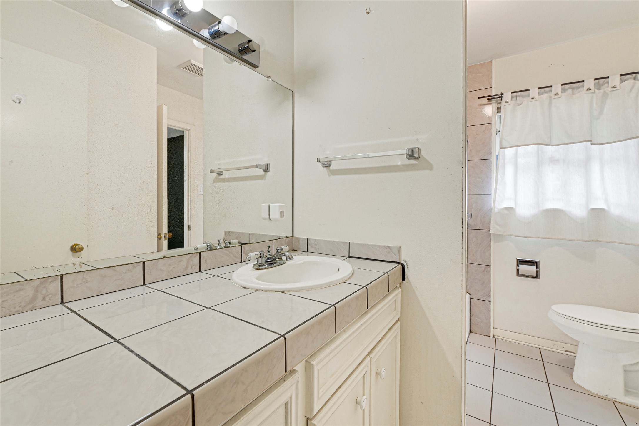 5510 Aldine Bender Road Houston, TX 77032 - Photo 15 of 24 a bathroom with a sink and a mirror