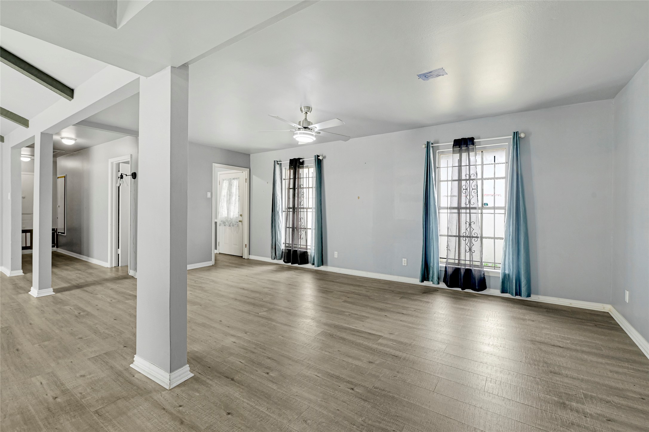 5510 Aldine Bender Road Houston, TX 77032 - Photo 5 of 24 an empty room with wooden floor and windows
