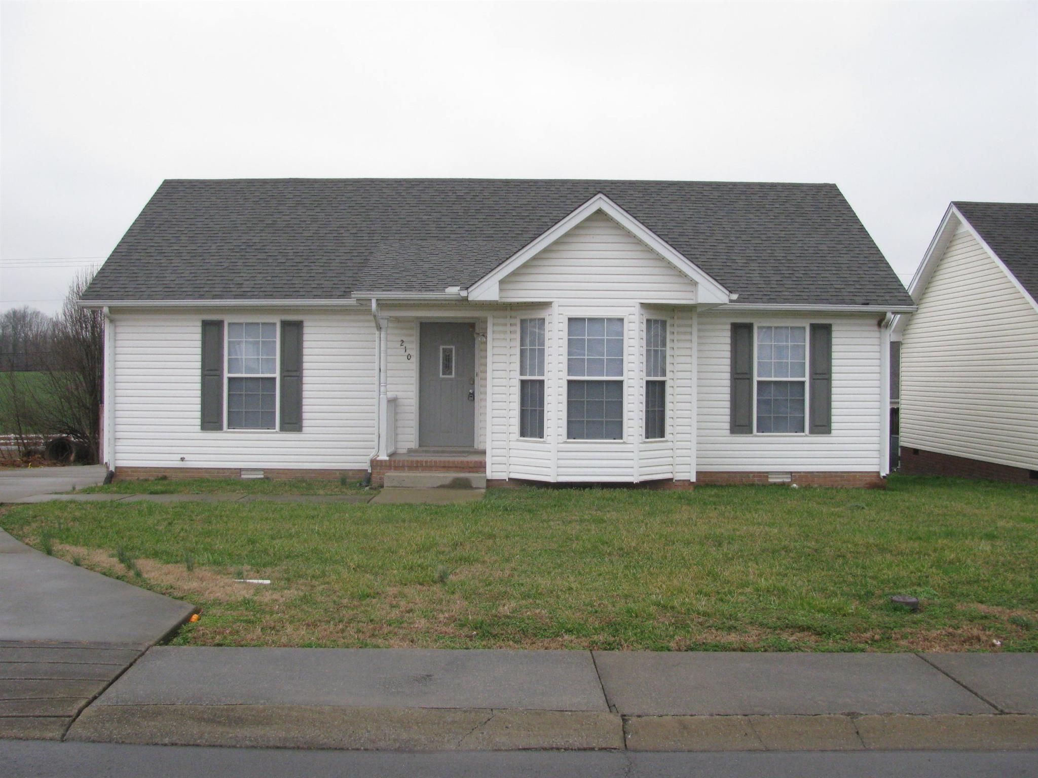 210 Travis Lane Springfield, TN 37172 - Photo 1 of 11 a front view of a house with a garden