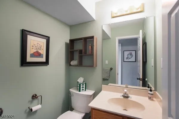 a bathroom with a sink mirror and toilet