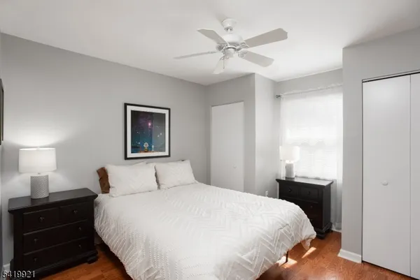 a bedroom with a bed and a lamp on dresser
