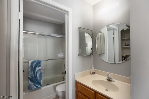 a bathroom with a shower sink and mirror