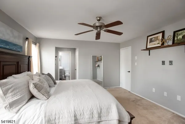 a bedroom with a large bed and a chandelier