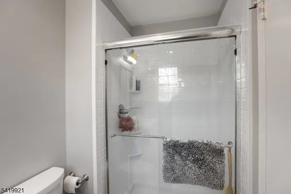 a bathroom with a glass shower door