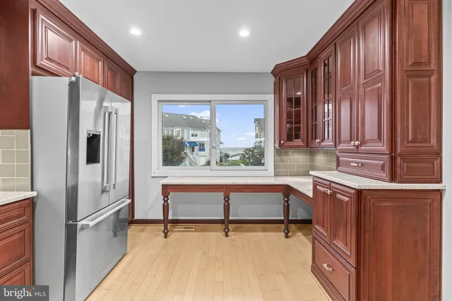 a spacious bedroom with a bed and a flat tv screen on the dresser