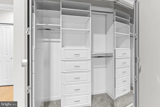 a living room with furniture and a dining table with rug